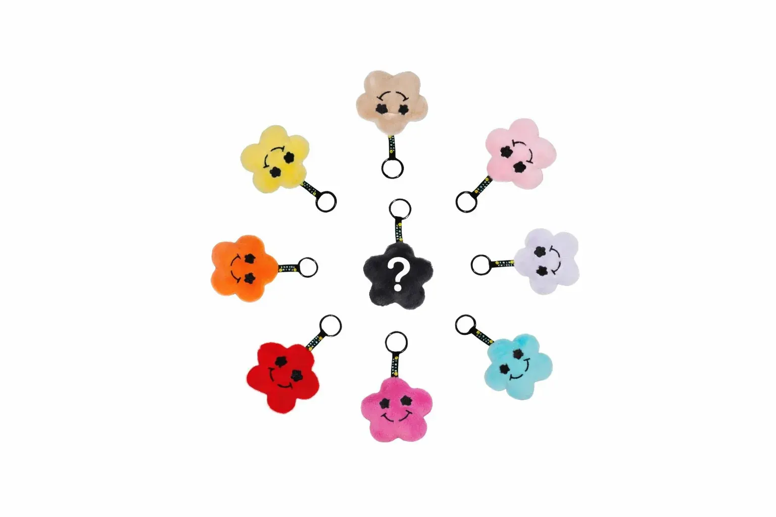 Collezione portachiavi a fiore peluche Twin Things con faccine smile in 8 colori: beige, giallo, rosa, arancione, lilla, rosso, fucsia, azzurro, più un nero mystery con punto interrogativo